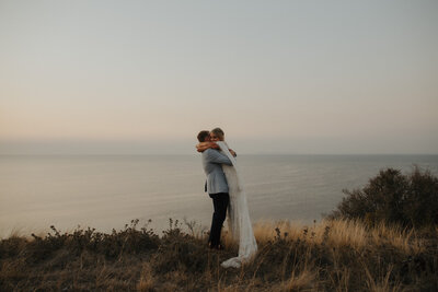 couple having portraits at sunset after their Baie wines ceremony