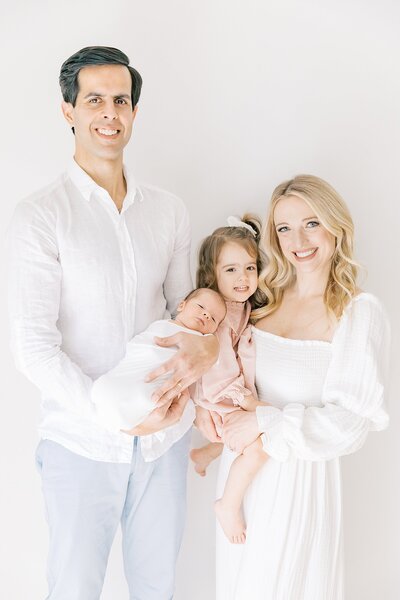 Family of four in soft neutral tones during a Charlotte studio family photography session, captured by Katie Petrick Photography