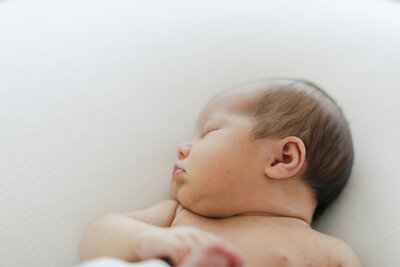 New Lenox newborn photographer Laurie Baker captures a baby in a Moses basket