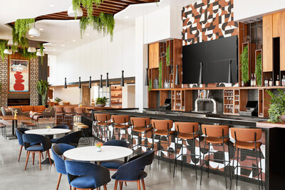 Image of the main floor restaurant bar with geometric wall pattern and bar stools