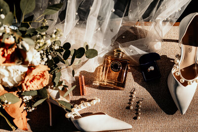 The bridal details  including her burberry goddess perfume, pearl earrings, pearl embellished veil, her engagement and wedding rings, lipstick and her bridal bouquet