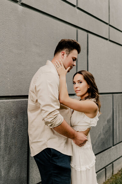 NY engagement couple posing against a wall