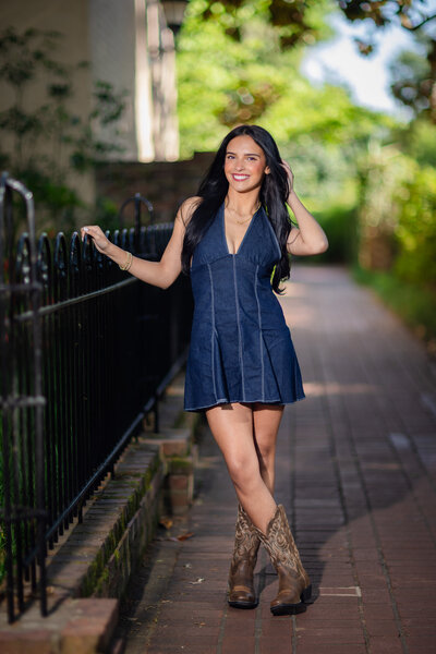 A girl posing for her senior portraits on the University of South Carolina's campus