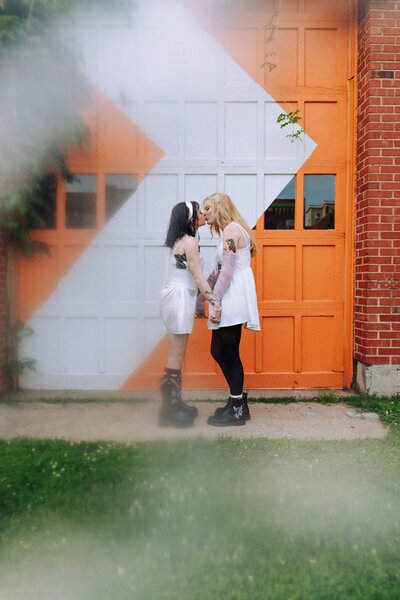 An indie LGBTQ+ couple’s moody editorial wedding portrait, photographed in a true-to-color style by Chelsea Stanford in Missouri