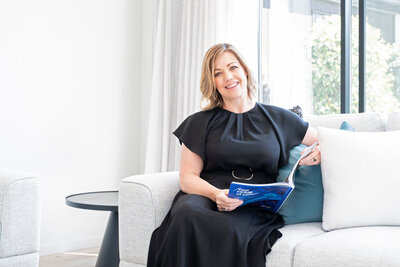 Picture of real estate agent Anna James sitting on a couch