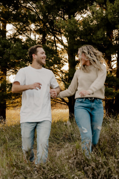 Romantic Omaha engagement session during the fall, captured by Tori Nichole Photography. The couple is surrounded by vibrant autumn foliage and golden light, creating warm, timeless moments. A perfect blend of natural beauty and authentic connection, showcasing the magic of the season and their love story.