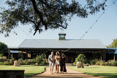 couple-walking-outside-texas-reception-venue