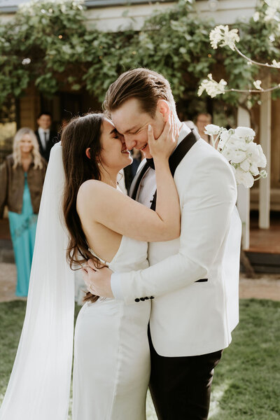 Bride and groom kissing each other after wedding in the yarra valley.