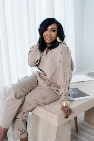 Marisa, trauma-informed therapist and founder of Restorative Oasis Counseling in Ohio and Colorado, seated in a calming therapy space
