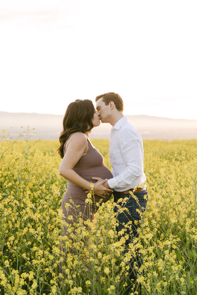 Couple in field in California for maternity photoshoot