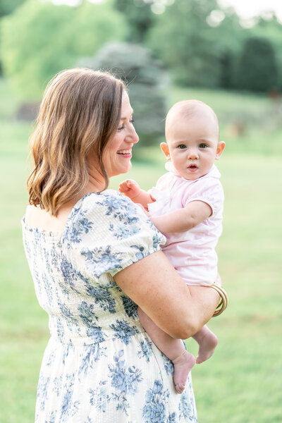 mama holding her little girl and smiling in baltimore maryland