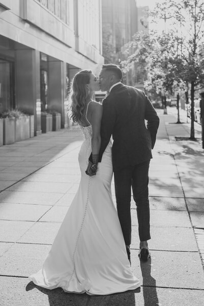 Northern Virginia wedding couple kissing walking down sidewalk