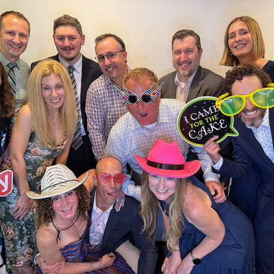 Group of guests posing with fun props at a photo booth