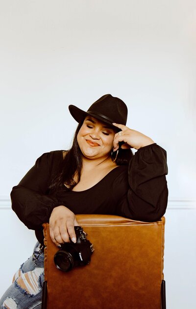 woman sitting on chair and holding camera