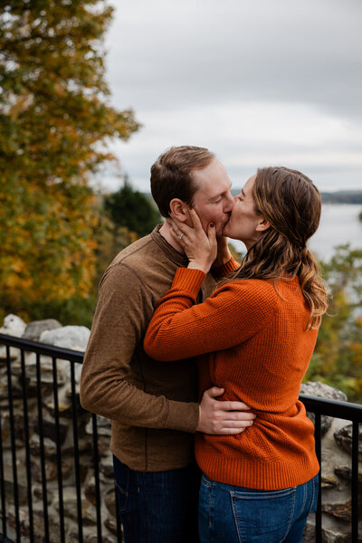 a couple kissing during their engagement photo shoot.