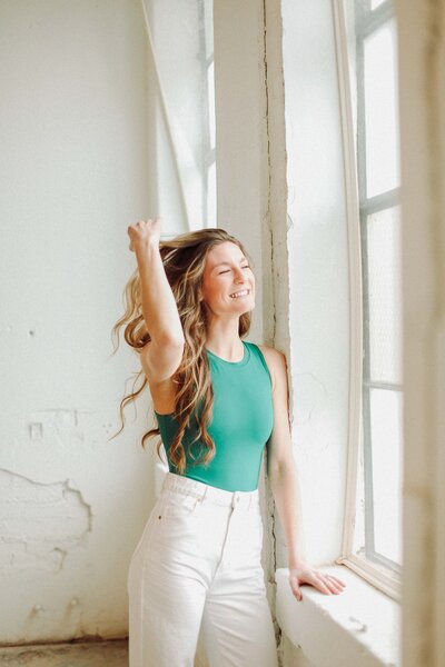 woman posing by window
