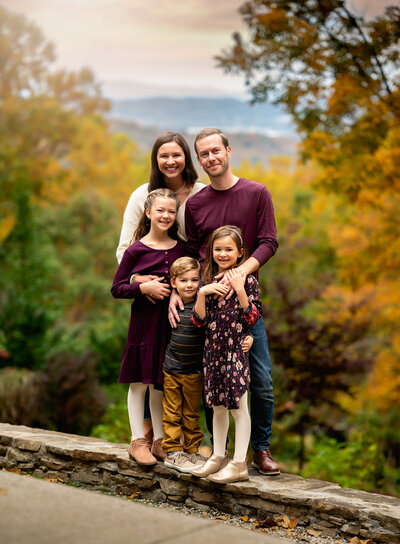 A family of five snuggling in front of their home in the mountains of Westen North Carolina