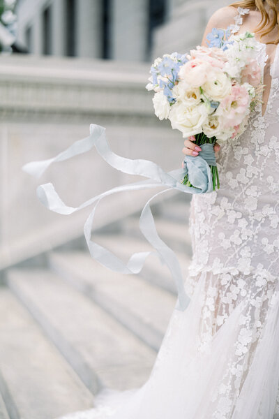 bridal bouquet in the wind wearing galia lahav gown