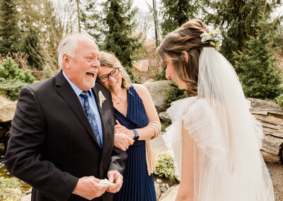 father beams with joy seeing his daughter for the first time in her wedding dress