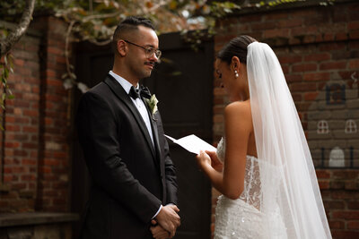 Groom tearing up while exchanging private vows with Bride