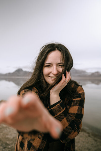 woman reaches out hand