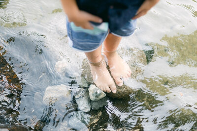 Little boys feet in river