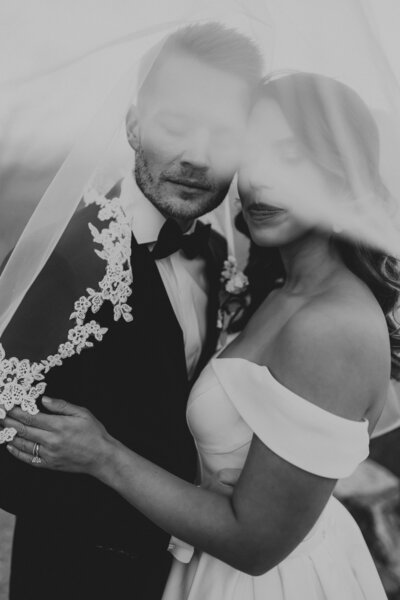 bride and groom holding each other's faces