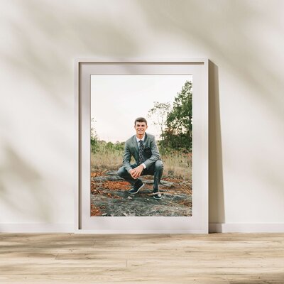 framframed photo of teen boy squatting in field during Springfield MO senior photography session MO senior photographer Jessica Kennedy of The XO Photography