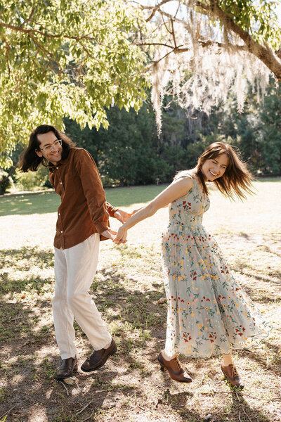 gainesville fl couple posing for engagement session under trees