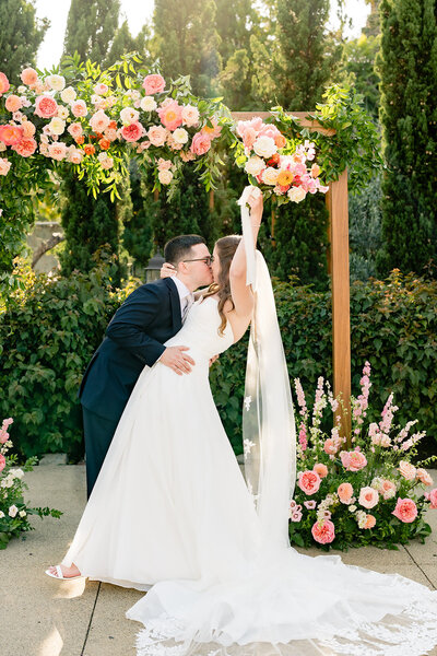 Bride and Groom holding hands and walking down the steps at their wedding at Estancia Hotel and Spa wedding venue