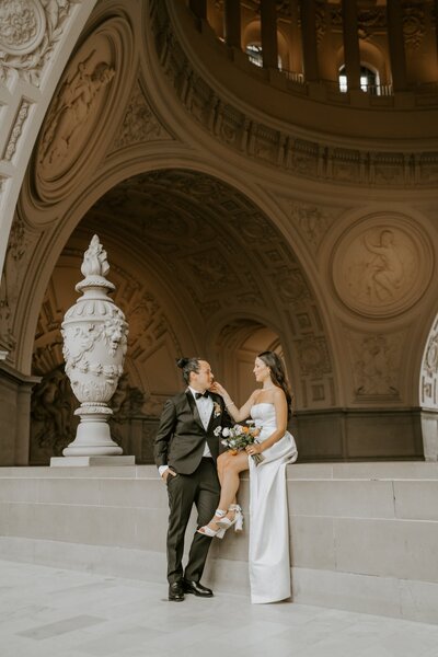 SF City Hall bride and groom posing for portrait