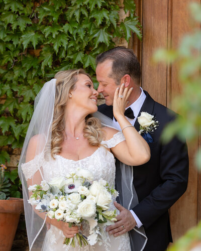 Wedding Photography in Paso Robles at Cali Paso Winery couples photos kissing with bouquet