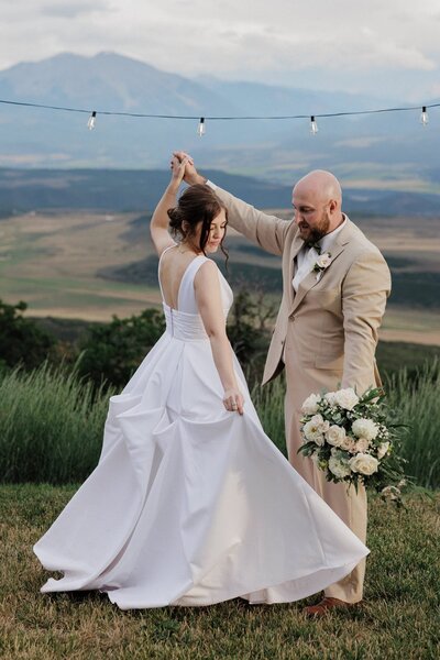 Bride and groom share first dance during intimate wedding  at Glenwood Springs Airbnb.