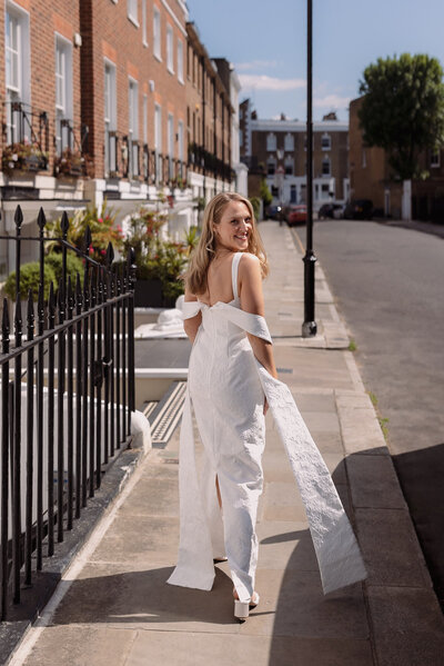 Wedding photographer captures couple taking a stroll hand in hand at their french chateau wedding.