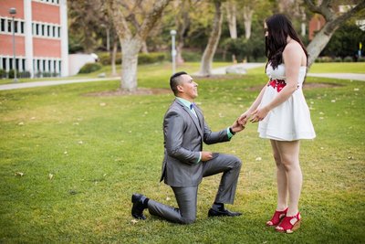 Groom to be gets down on one knee to propose marriage to his girlfriend on the campus of Cal Poly Pomona