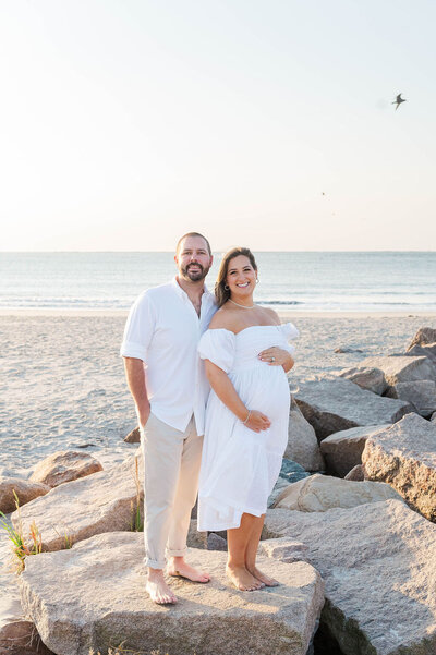 Best Maternity photographer in Westwood, MA shot of husband and wife with pregnant belly