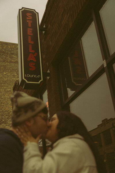Man and woman romantically spin around, laughing in the middle of a  flowery field