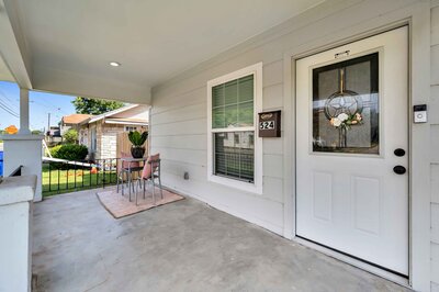 Front porch with quaint seating at this three-bedroom, two-bathroom vacation rental house just 5 minutes from The Silos in downtown Waco, TX.