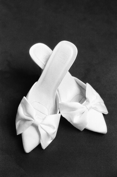 Estate at River Run Wedding in Richmond VA | black and white film image of white bridal shoes with a bow