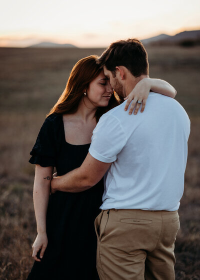 Kyleigh Fulwider and Gabe Torres share a kiss during engagement photos at Lake Arcadia in Edmond, Oklahoma.