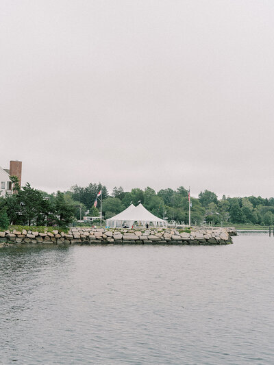 Water with a tent in the background.
