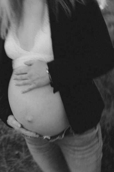 Detailfoto van zwangere vrouw met blote buik.