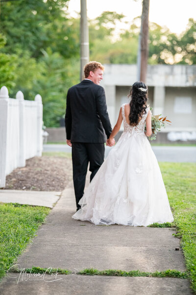 Bride and Groom walking away from camera