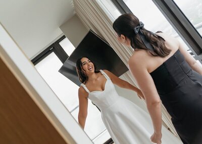 Bride and bridesmaid about to embrace taken by Shelby Ann photos, jacksonville wedding photographer