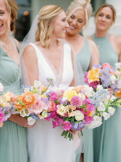 Bride and bridesmaids with colorful bouquets at wedding planned by Bianca Nichole and Co