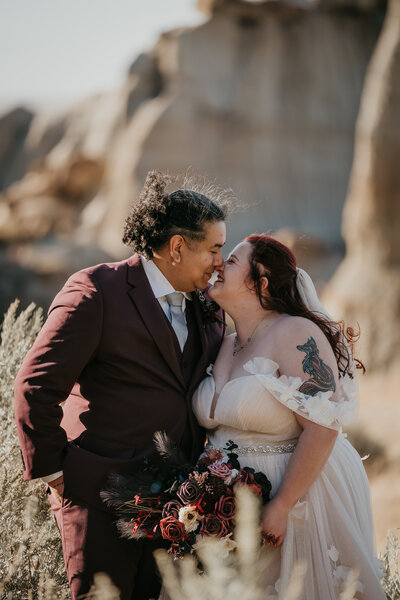 Wedding photo session in North Dakota, capturing a couple's emotional moment with stunning details, including the bride’s bouquet and flowing dress against a beautiful backdrop.