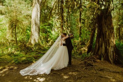 Bride walking alone on forest trail during Oregon elopement