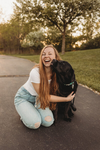 woman smiling with two dogs