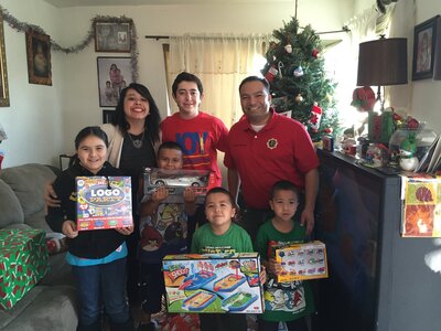 JOY volunteers with children and their toys