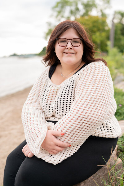 Plus size senior girl smiles on the beach.